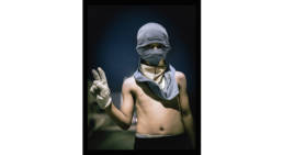 A young boy attends a night protest. Manama, Bahrain, 2013.